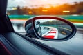 Car's side view mirror captures racing track with rain drops on it as the sun shines through. Generative AI Royalty Free Stock Photo