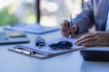 Car sales concept, sales reps give keys to customers on table with small car