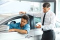 Car Sales Consultant Showing a New Car to a Potential Buyer in S Royalty Free Stock Photo