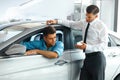 Car Sales Consultant Showing a New Car to a Potential Buyer in S Royalty Free Stock Photo