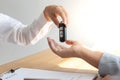 The car salesman handed the keys to the customer who passed the car purchase loan conditions Royalty Free Stock Photo