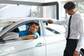 Car Salesman Handing over new Car Key to Customer at Showroom Royalty Free Stock Photo