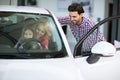 Car salesman handshaking with cheerful buyer Royalty Free Stock Photo