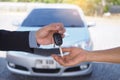 Car salesmen send keys to new car owners. Used car sales agency, car rental