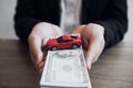 Car salespeople are submitting cash with model cars to customers with concept of buying a new car Royalty Free Stock Photo