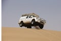 A car on sand dune, Africa Royalty Free Stock Photo