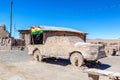 Salty Jeep sculpture and Bolivian Flag in salt flat Salar de Uyuni, Bolivia Royalty Free Stock Photo