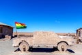 Car sculpture and Bolivian Flag in salt flat Salar de Uyuni, Bolivia Royalty Free Stock Photo