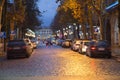 Car searching parking space at night in city or town center. Vehicle trying to find place to park and stop. Beautiful old vintage