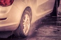 The car is at a self-service car wash, Close up of washing a car using high pressure water jet and washing with foam Royalty Free Stock Photo