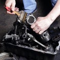 Car service - Engine repair mechanic hands wash out the piston a brush