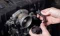 Car service - Engine repair mechanic hands wiring terminal