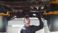 Car service - a mechanic checks the suspension of SUV Royalty Free Stock Photo