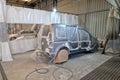 Car service paint booth with car prepaired for painting