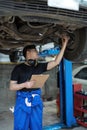 car service, repair, maintenance and people concept - happy smiling auto mechanic man or smith with clipboard at Royalty Free Stock Photo