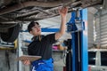 car service, repair, maintenance and people concept - happy smiling auto mechanic man or smith with clipboard at Royalty Free Stock Photo