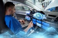 Mechanic man with laptop making car diagnostic Royalty Free Stock Photo