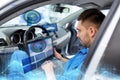 Mechanic man with laptop making car diagnostic Royalty Free Stock Photo