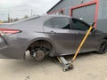 Car in a car service, repair of wheels. Concept: tire fitting, vulcanization, tire change. Car on a jack, changing wheels. Kiev