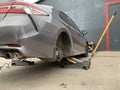 Car in a car service, repair of wheels. Concept: tire fitting, vulcanization, tire change. Car on a jack, changing wheels. Kiev