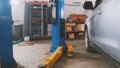 Car service - white vehicle in workshop for repairing or checking