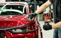 Car service worker applying nano coating on a car detail.