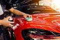 Car service worker applying nano coating on a car detail Royalty Free Stock Photo