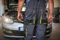 Car service worker diagnoses car breakdown Royalty Free Stock Photo