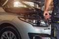 Car service worker diagnoses car breakdown Royalty Free Stock Photo