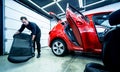 Car service worker disassemble the interior of the car