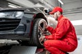 Car service worker changing wheel Royalty Free Stock Photo