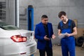Car service worker talking to a customer about a repair Royalty Free Stock Photo