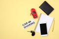 Car sharing service concept. Red toy car, agreement, vehicle key, smartphone, auto driver license and text sign Royalty Free Stock Photo