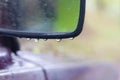 Car side mirror in the rain in water drops Royalty Free Stock Photo