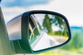 Car side mirror with a reflection of the beautiful scenery in it Royalty Free Stock Photo