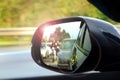 Car side mirror view with sunlight glare Royalty Free Stock Photo