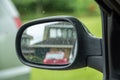 Car side rear-view mirror with house reflection Royalty Free Stock Photo