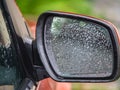 car side rear view mirror with rain drops Royalty Free Stock Photo