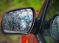 car side rear view mirror with rain drops Royalty Free Stock Photo