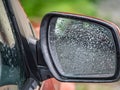 car side rear view mirror with rain drops Royalty Free Stock Photo