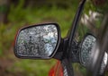 Car side rear view mirror with rain drops Royalty Free Stock Photo