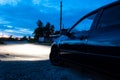 Car side view from behind. polished car. night. headlights light Royalty Free Stock Photo