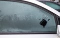 Car side window covered with ice hoar frost in winter. Royalty Free Stock Photo