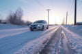 car skidding marks on an icy road with snowbanks