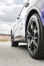 Car on sky background. Car wheels close up on a background of asphalt. Car tires. Car wheel close-up. for advertising Royalty Free Stock Photo