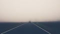 A car on a very foggy countryside road Royalty Free Stock Photo