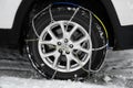 Car with snow chain on tire, closeup Royalty Free Stock Photo