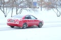 Car on a snow-covered road after high snow-storm in Moscow