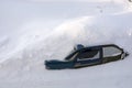 Car in the snow top view. The passenger car was covered with snow. A car in a snowdrift