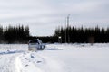 A white car rides on a winter road on a frosty day Royalty Free Stock Photo